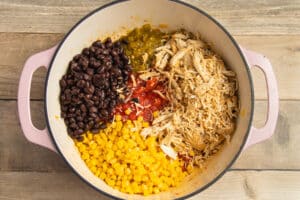 This is a picture of a pot with beans, corn, chicken added.