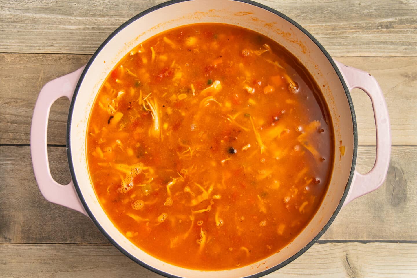 This is a picture of a pot with broth added.