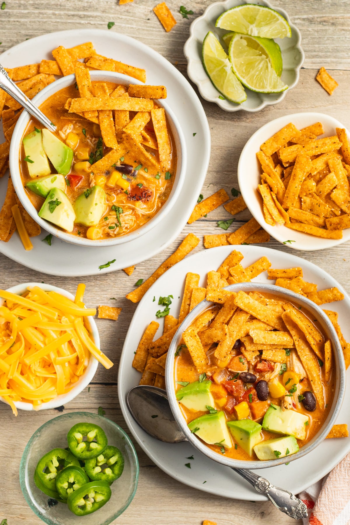 This is a picture of 2 bowls of creamy chicken tortilla soup.