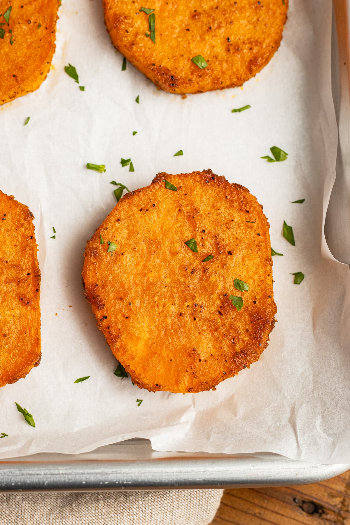 This is a picture of a sheet of roasted sweet potato slices.