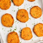 This is a picture of a sheet of roasted sliced sweet potato slices.