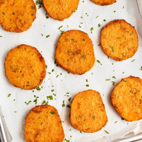 This is a picture of a sheet of roasted sliced sweet potato slices.