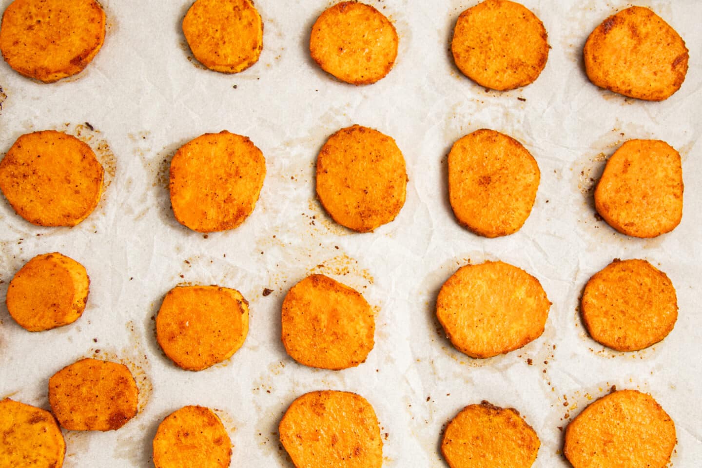 This is a picture of the sliced sweet potatoes on the baking sheet after roasting.