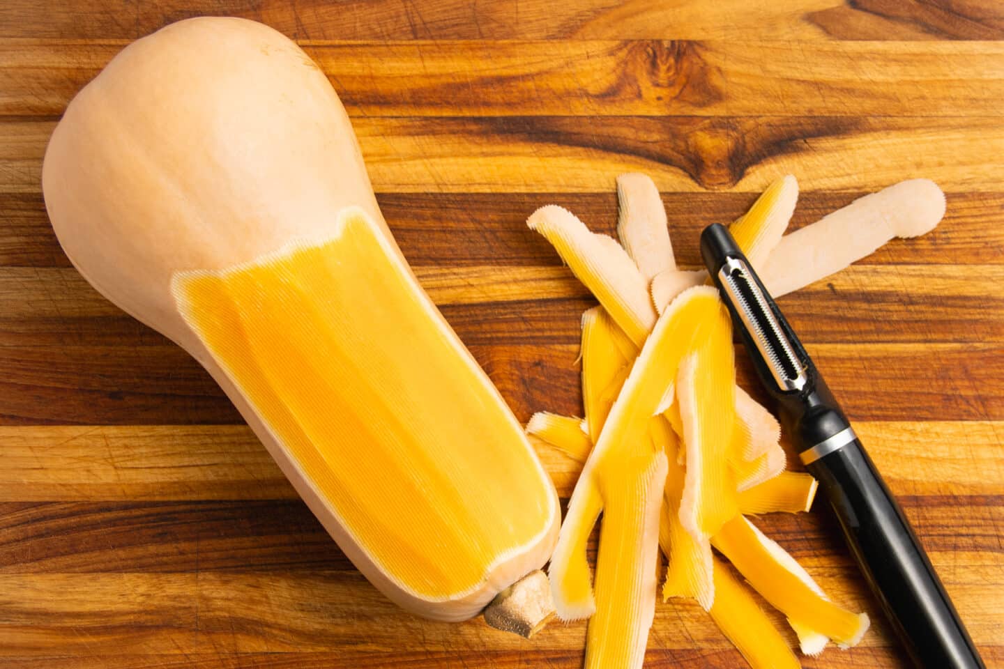 This is a picture of a butternut squash getting peeled.