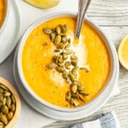 This is a picture of a bowl of carrot and cauliflower soup.