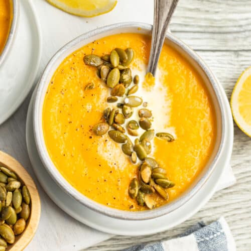 This is a picture of a bowl of carrot and cauliflower soup.