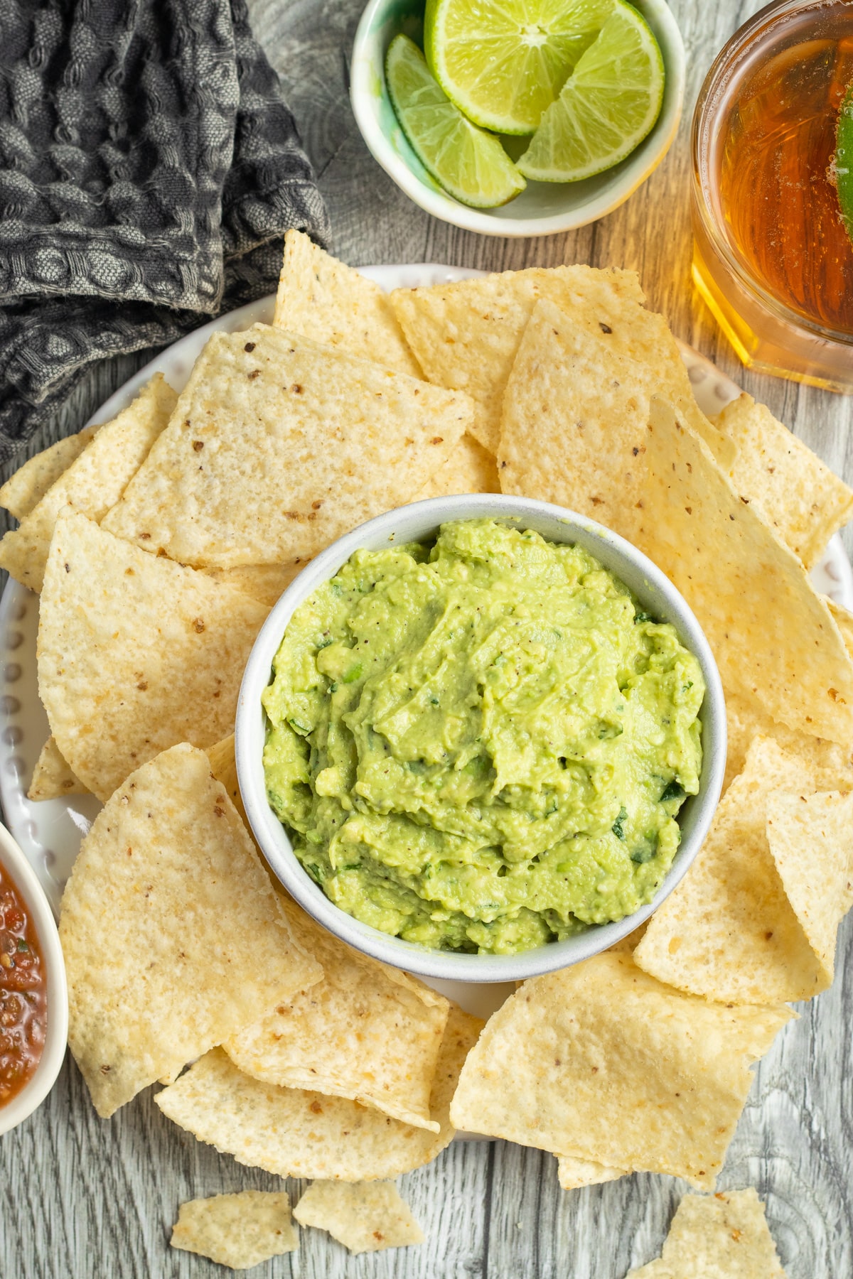 This is a picture of a bowl of guacamole with chips.