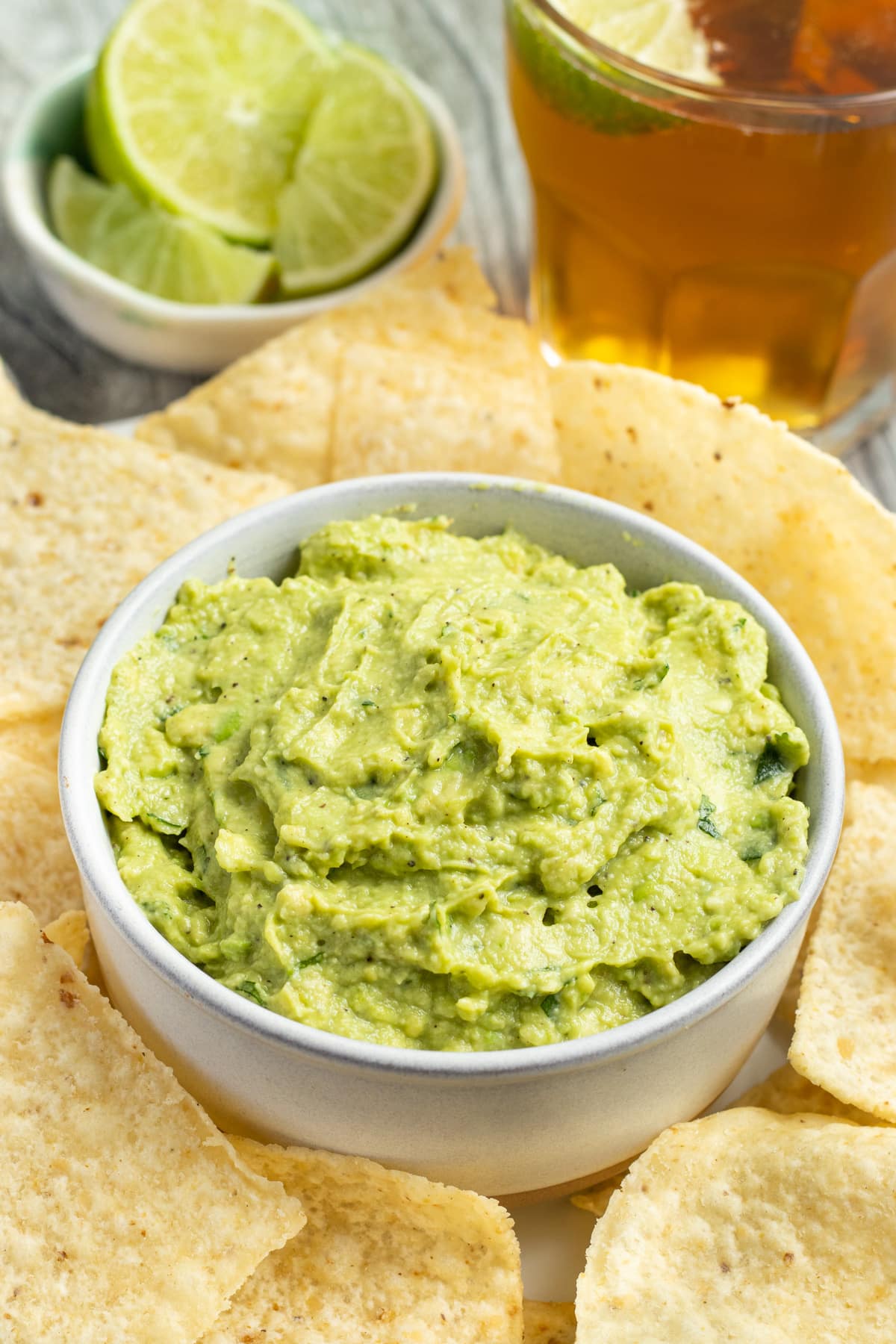 This is a picture of a bowl of guacamole with chips.