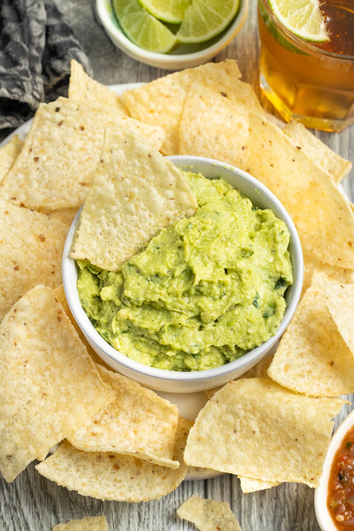 This is a picture of a bowl of guacamole with chips.