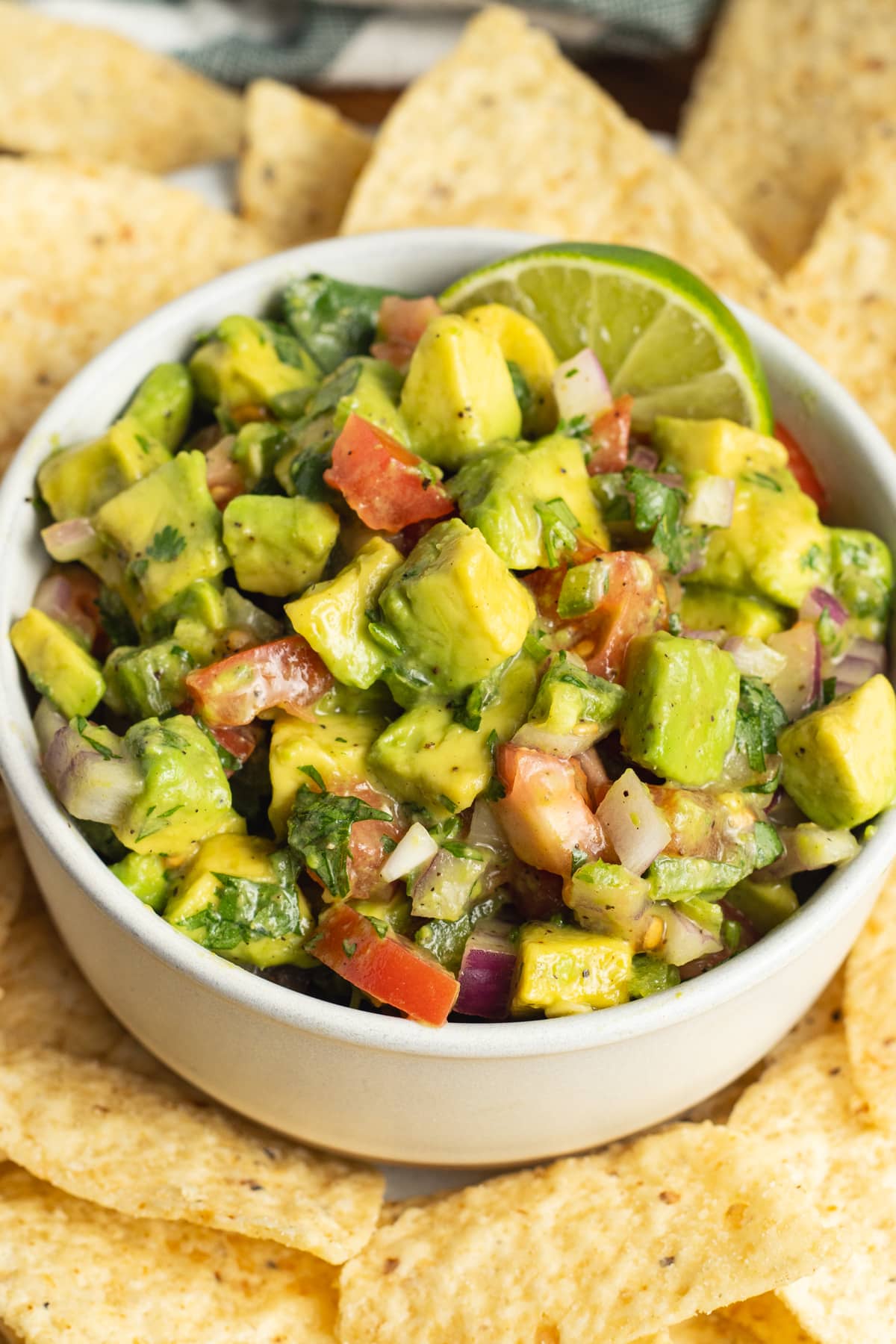 This is a picture of a bowl of avocado pico de gallo salsa.