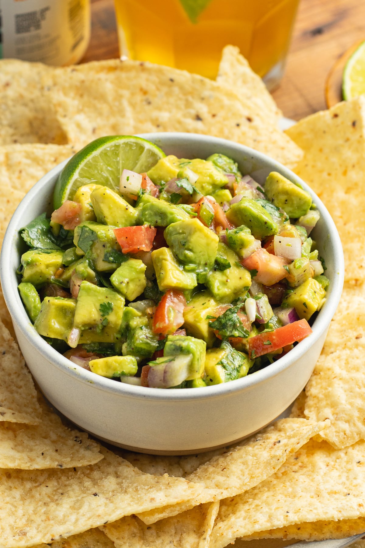 This is a picture of a bowl of avocado pico de gallo salsa.