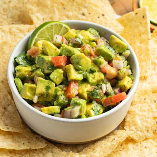 This is a picture of a bowl of avocado pico de gallo salsa.