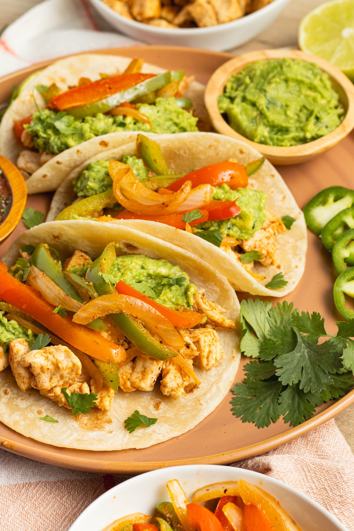 This is a picture of chicken fajita tacos on a plate.