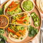 This is a picture of chicken fajita tacos on a plate.