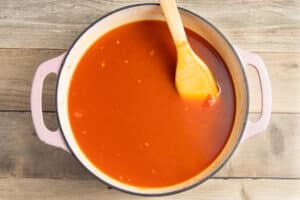 This is a picture of a pot with the broth added to the veggies.