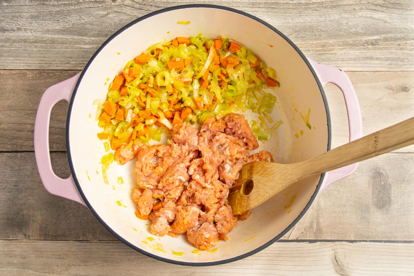 This is a picture of the pot with sausage added to the carrots and leeks.