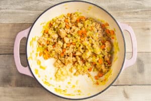 This is a picture of the pot with garlic added to the sausage, carrots and leeks.